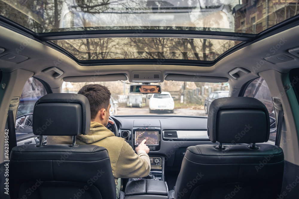 Man touching screen of a GPS navigation system in his car. Man touching screen of a GPS navigation system in his car.