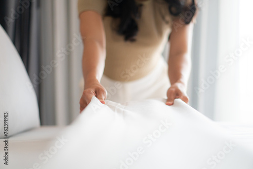 Canvas Print Housewife set up white sheet and cleaning in room. Housewife