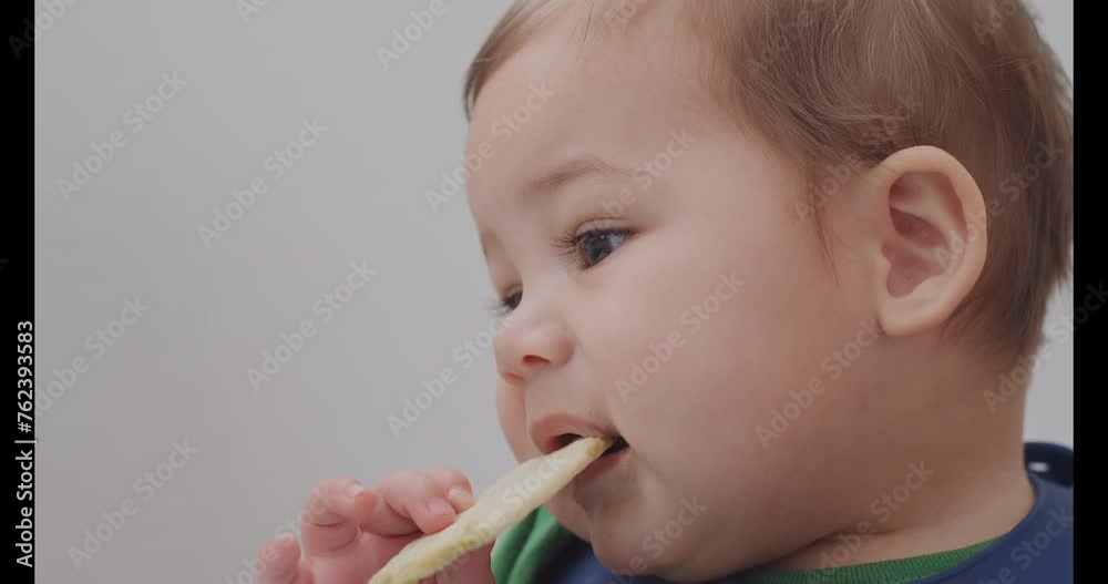 Baby boy chewing on a teething cracker Baby boy chewing on a teething cracker