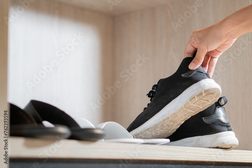Girl puts on sneakers after returning from a walk at the closet
