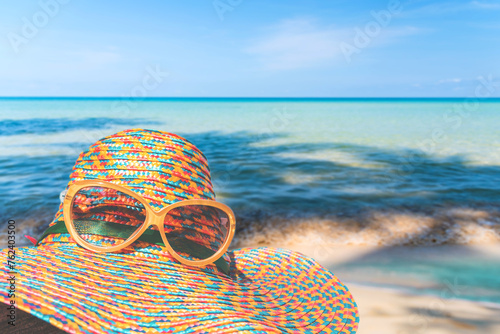 Straw hat on the beach with sea and sky on island background, Summer vacation concept 