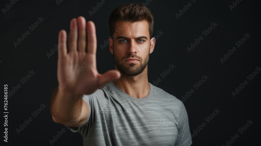 Man Making a Stop Sign Gesture With His Hand at a Crosswalk Man Making a Stop Sign Gesture With His Hand at a Crosswalk