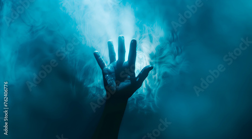 Silhouetted hands reaching out through a misty blue haze, creating a mysterious and eerie atmosphere