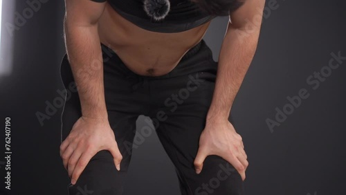 A detailed view of a man practicing abdominal yoga vacuum exercises to enhance posture and spinal alignment.