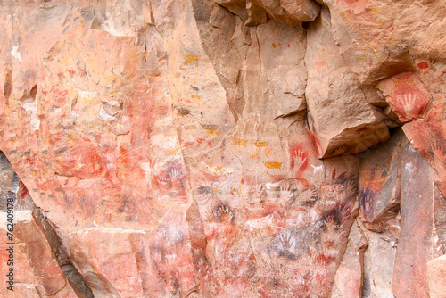 Colourful animal rockpaintings and handprints on rock walls at Cueva de las Manos, UNESCO World Heritage Site, Patagonia, Argentina photo