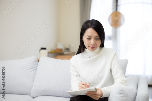 Woman write on the notebook at home