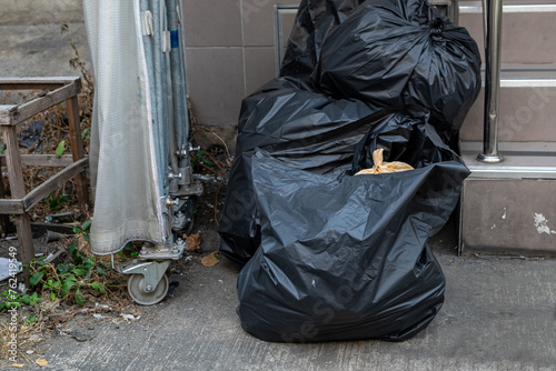 A Large Number of Garbage Bags Left in Front of the House, Waiting for the Garbage Truck to Come and Take Them Away for Disposal