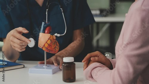 Cardiology consultation, treatment of heart disease. Doctor cardiologist while consultation showing anatomical model of human heart