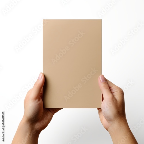 A hand holding a khaki paper isolated on white background