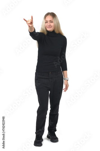 front view of a woman showing the horns sign with fingers looking at camera on white background