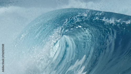 Perfect blue ocean wave breaks on the shore in the Maldives. Honeymoon surfing spot near the island of Himmafushi