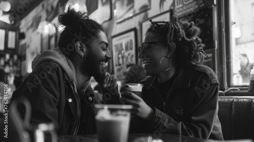 Happy man and woman are seated at a table in a restaurant, engaged in conversation and enjoying a meal together