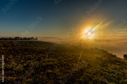 Foggy sunrise over the horizon, Tuscan valley, Tuscany, Italy