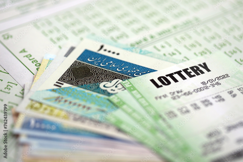 Green lottery tickets and iranian money bills on blank with numbers for playing lottery close up Green lottery tickets and iranian money bills on blank with numbers for playing lottery close up