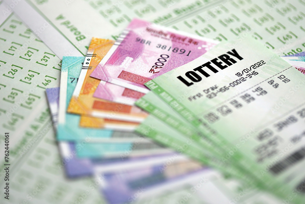 Green lottery tickets and indian rupees money bills on blank with numbers for playing lottery close up Green lottery tickets and indian rupees money bills on blank with numbers for playing lottery close up