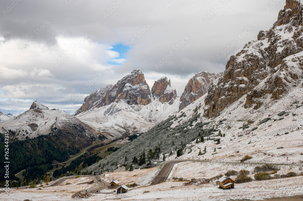 The road in the Passo Pordoi valley with snow, Pordoijoch and the Dolomites Alps, Passo Pordoi, Val Gardenna, South Tyrol, Dolomites, Italy.