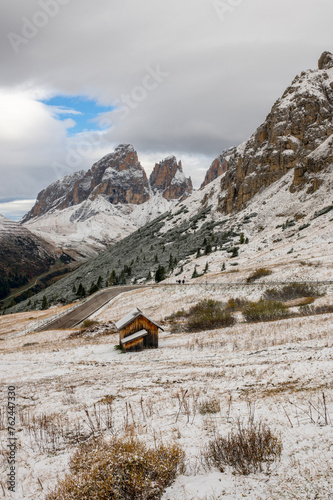 The road in the Passo Pordoi valley with snow, Pordoijoch and the Dolomites Alps, Passo Pordoi, Val Gardenna, South Tyrol, Dolomites, Italy.