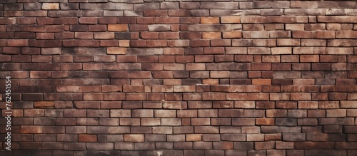 A close up of a brown brick wall showcasing the intricate brickwork pattern and texture. The blurred background highlights the building materials composite nature