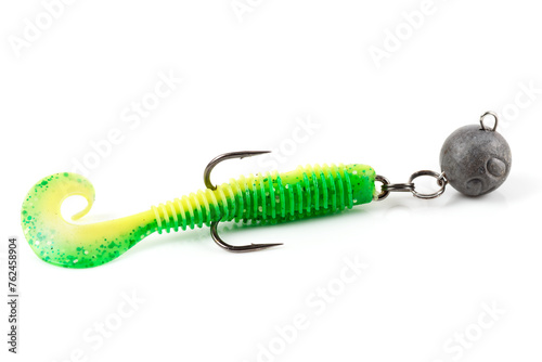 Soft fishing bait for predatory fish, green plastic grub, with double hook and lead sinker, isolated on white