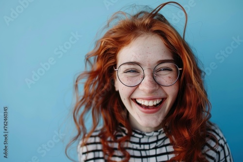 woman smiling with spectacles on blue background stock photo ukt photo