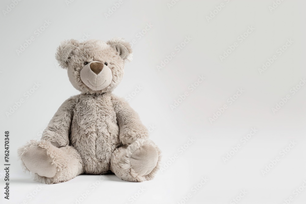 small stuffed bear sitting against a white background small stuffed bear sitting against a white background