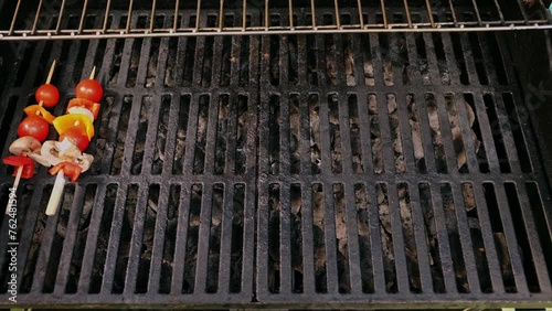 Close-up of a cook's hands carefully placing the vegetables on a grill net