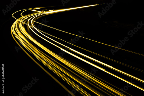 gold car lights at night. long exposure