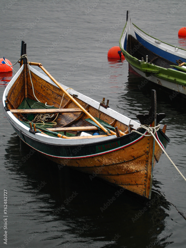 wooden rowboat on the water