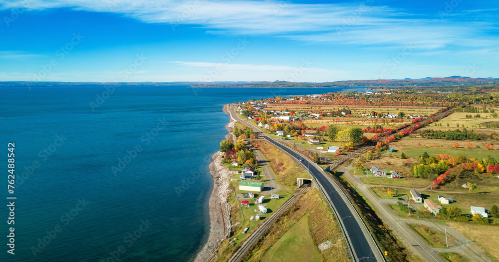 Vibrant landscape on the East Coast of Atlantic Ocean. with road and town. Sunrise Vibrant landscape on the East Coast of Atlantic Ocean. with road and town. Sunrise