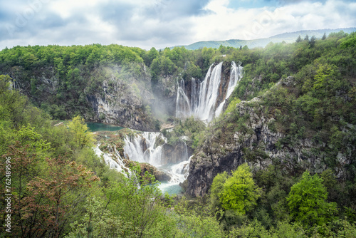 Amazing aerial view of Plitvice national park with lakes and picturesque waterfalls in a green spring forest  Croatia.