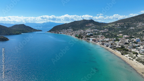 Aerial drone photo of famous seaside village small port and long sandy beach of Tolo with hotels and resorts built by the sea, Argolida, Peloponnese, Greece © aerial-drone