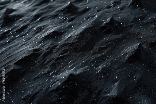 Free photo dark black rough surfaced background and splashing water stream