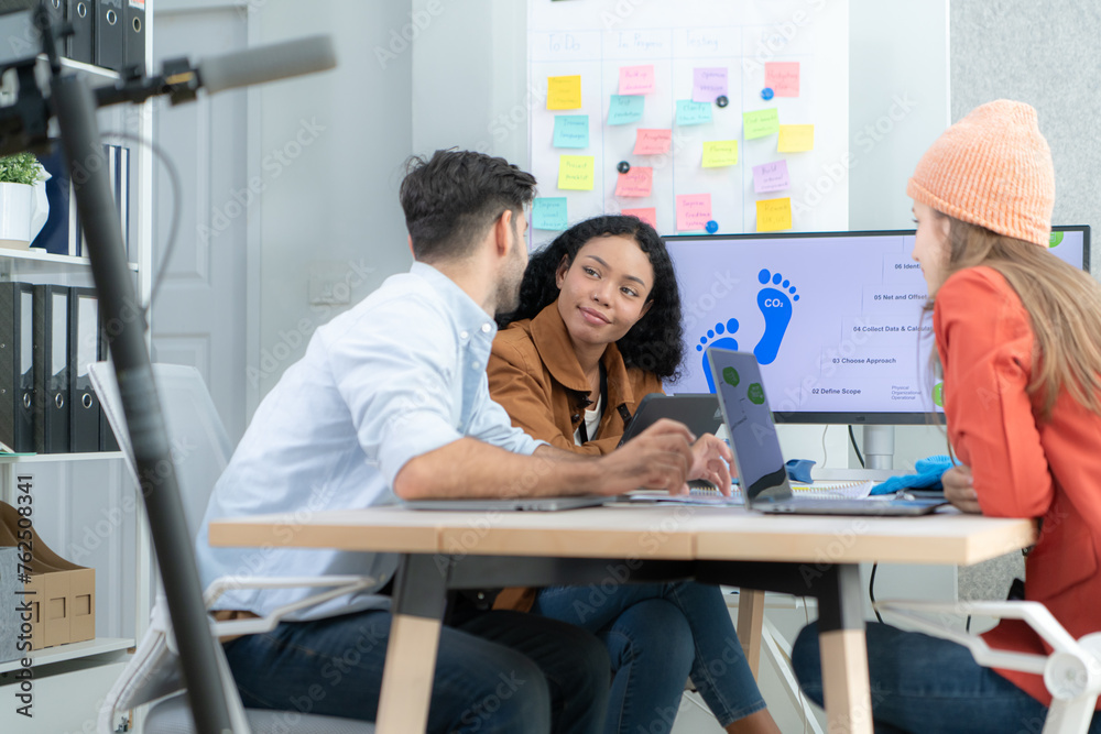 Fototapeta premium Multiethnic startup business team on meeting in modern bright office interior brainstorming, working on laptop and tablet computer