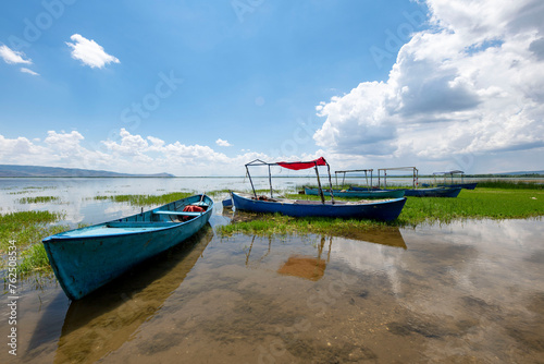 Fototapeta Naklejka Na Ścianę i Meble -  Decorated day-trip boats in Isikli Lake in Denizli's Civril district. Isıkli Lake is flooded with visitors during lotus time. It is also a popular lake for hunters.