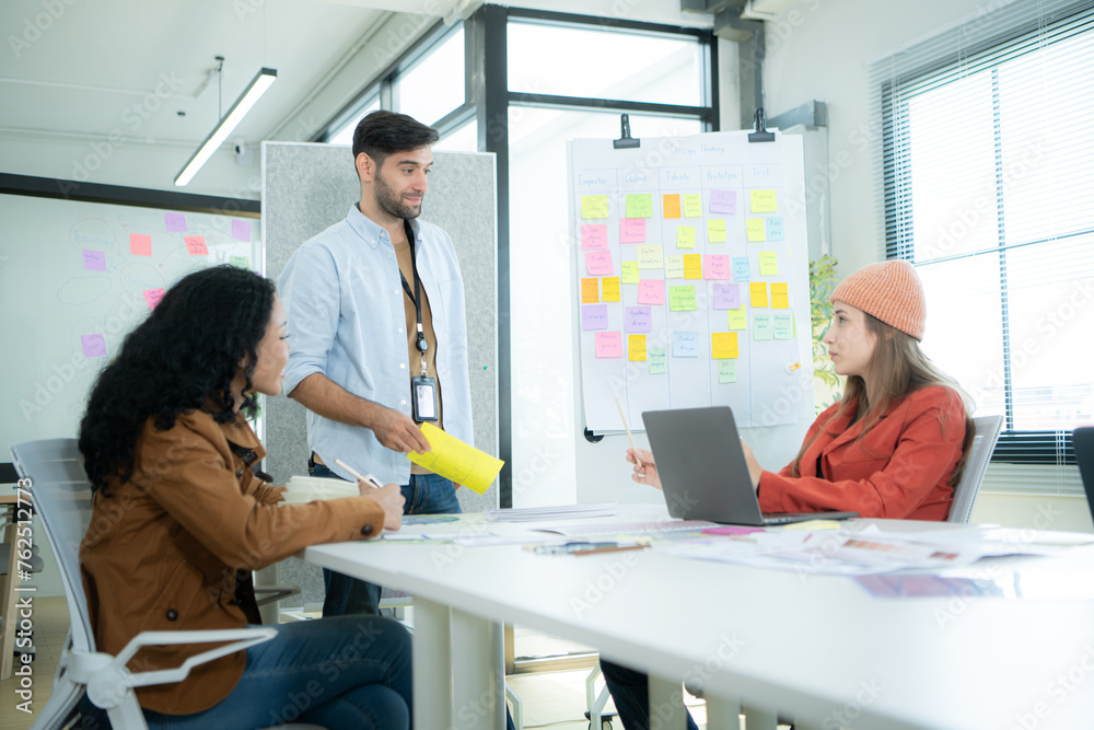 Multiethnic young business people working together in modern office, Collaborate to designing an application for use on the internet network. Multiethnic young business people working together in modern office, Collaborate to designing an application for use on the internet network.