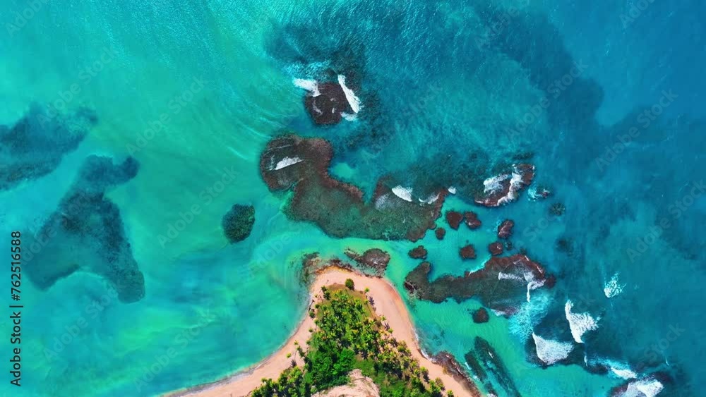 Beautiful background of the seabed through crystal clear turquoise water. Majestic sea life. Travel and vacation concept. Bright coral reef in the tropical sea. Small island in the Caribbean Sea.
