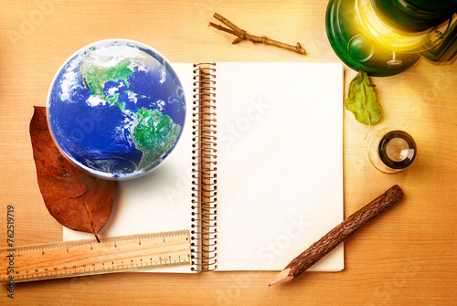 Natural and Save Earth observer concept, globe Earth, Notebook, pencil, lamp, loop and ruler on wood table Elements of this image furnished by NASA
