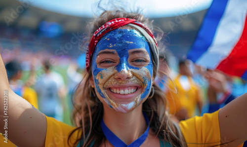 Vibrant Portrait of a Joyful Female French Supporter with a French Flag Painted on Her Face, Celebrating at UEFA EURO 2024