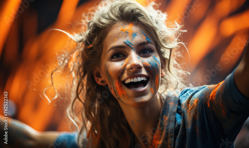Portrait of a passionate female Dutch fan celebrating at a UEFA EURO 2024 football match, her face painted with the colors and patterns of the Dutch flag, radiating enthusiasm and national pride © Bartek