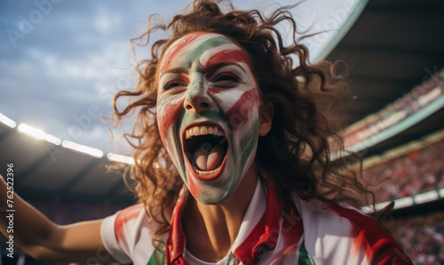 Portrait of a passionate female Hungarian fan celebrating at UEFA EURO 2024 football match, her face painted with the colors and patterns of the Hungarian flag, radiating enthusiasm and national pride