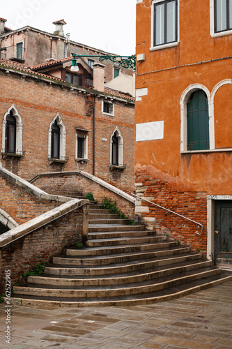 Cozy narrow canals of Venice city with old traditional architecture, bridges and boats, Veneto, Italy. Tourism concept. Architecture and landmark of Venice. Cozy cityscape of Venice.