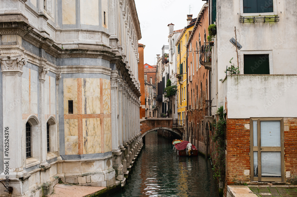 Cozy narrow canals of Venice city with old traditional architecture, bridges and boats, Veneto, Italy. Tourism concept. Architecture and landmark of Venice. Cozy cityscape of Venice.