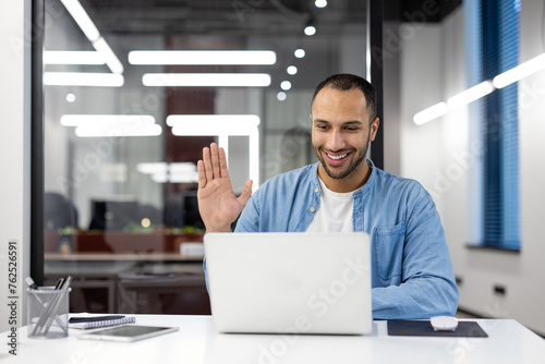 Friendly businessman greeting during a video call