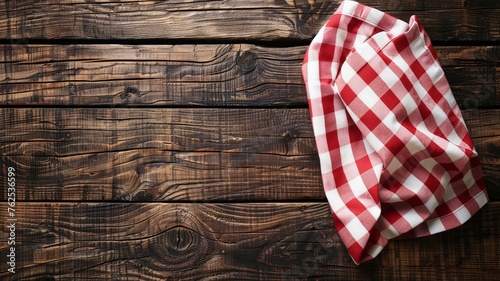 Rustic elegance of a red and white checkered napkin on dark wood texture