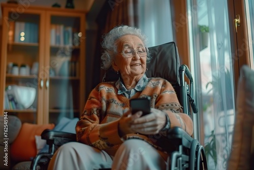 Embracing Technology Portrait of a Smiling Senior Woman on Wheelchair, Engaging with the Digital World through Her Smartphone at Her Comfortable Living Home © photobuay