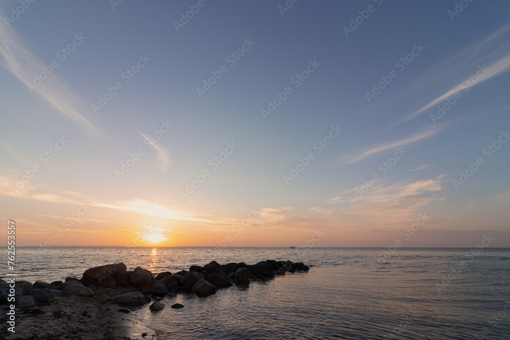 Obraz premium Sescape with rock groyne at sunset., copy space