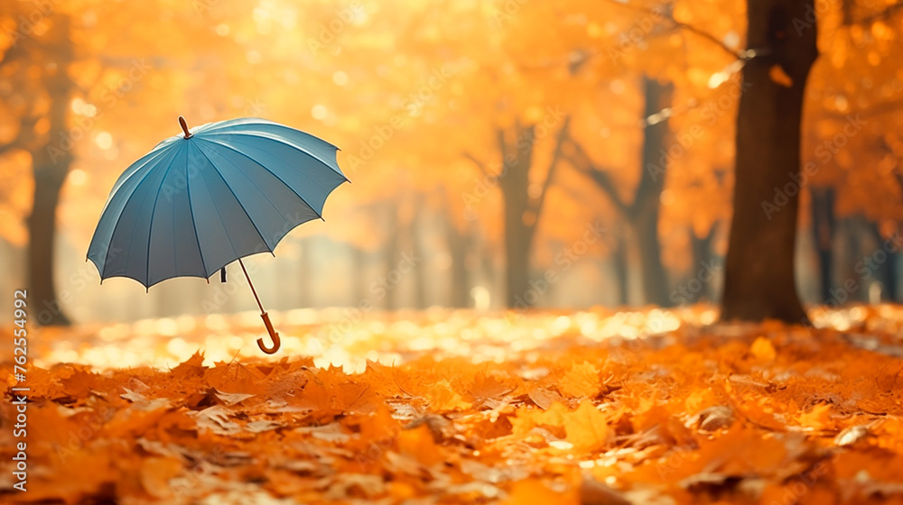 a blue umbrella sitting in a field of leaves