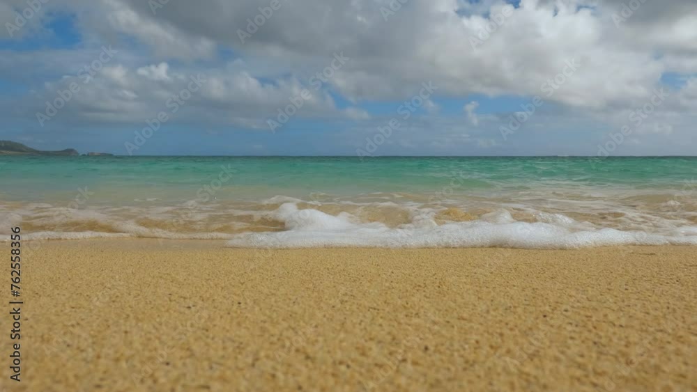 Lanikai Beach on Oahu, Hawaii. Low-angle pov shot of waves rolling on beach and flipping the camera upside down. Lanikai Beach on Oahu, Hawaii. Low-angle pov shot of waves rolling on beach and flipping the camera upside down.