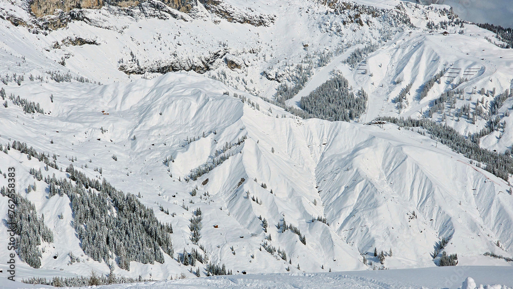 Heavy snow covered mountains and ski resort from above on a sunny day. Dolomites mountains, Italy, South Tyrol. Beautiful bird view from Dolomiti Superski area. Heavy snow covered mountains and ski resort from above on a sunny day. Dolomites mountains, Italy, South Tyrol. Beautiful bird view from Dolomiti Superski area.