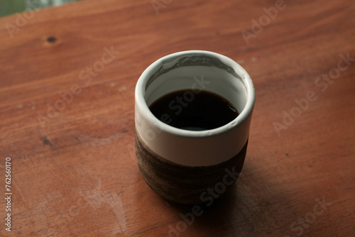 V60 filter coffee in an aesthetic ceramic cup on a wooden table